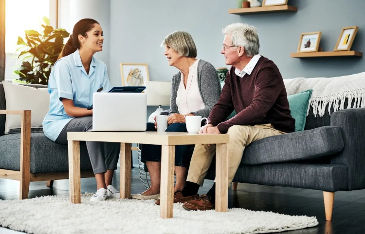 Shot of a young nurse having a discussion with a senior couple