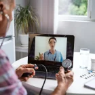 Senior man make distant video call communicating with doctor online.
